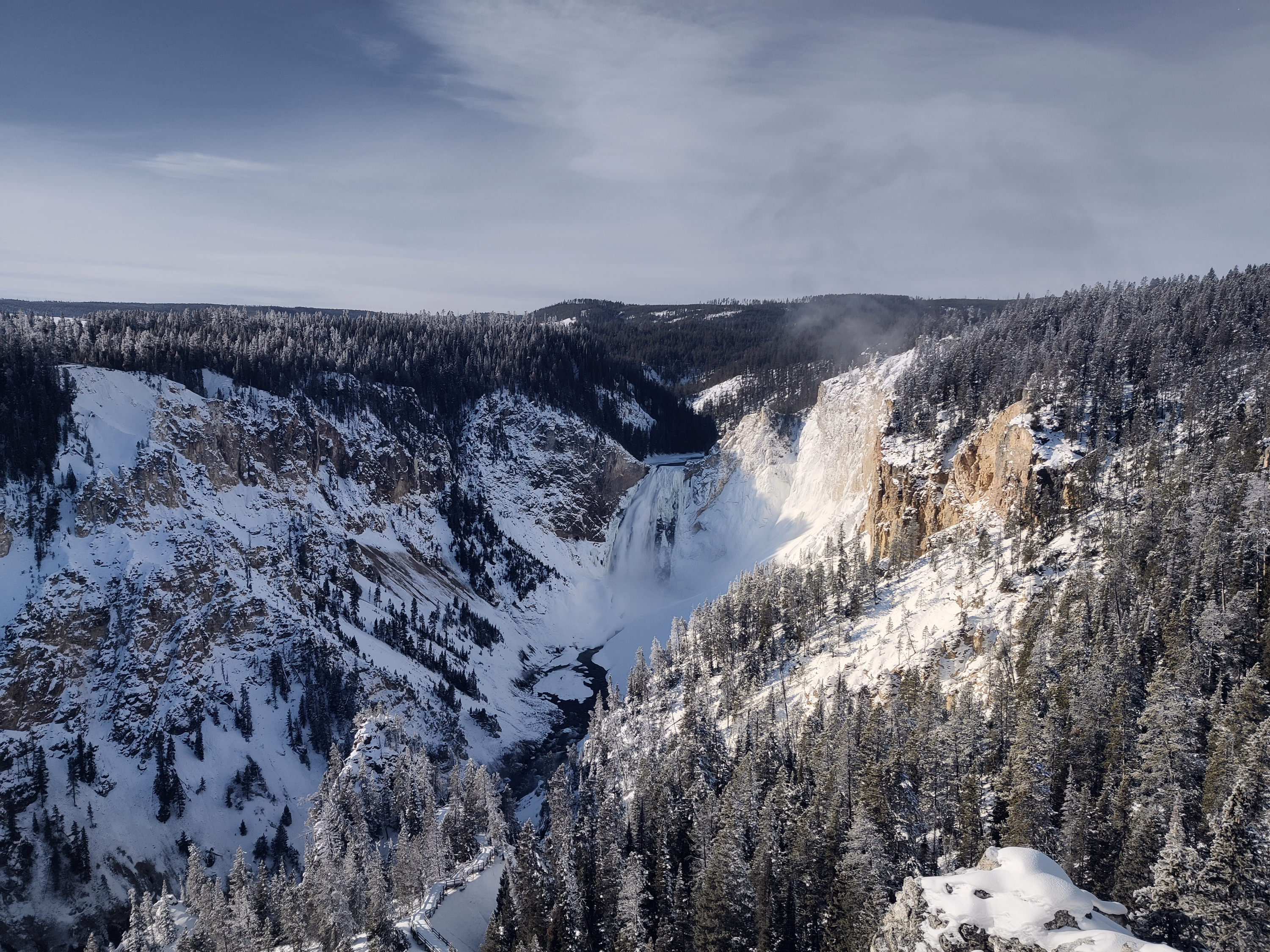 The Lower Falls drops into the snow-filled Grand Canyon of the Yellowstone.